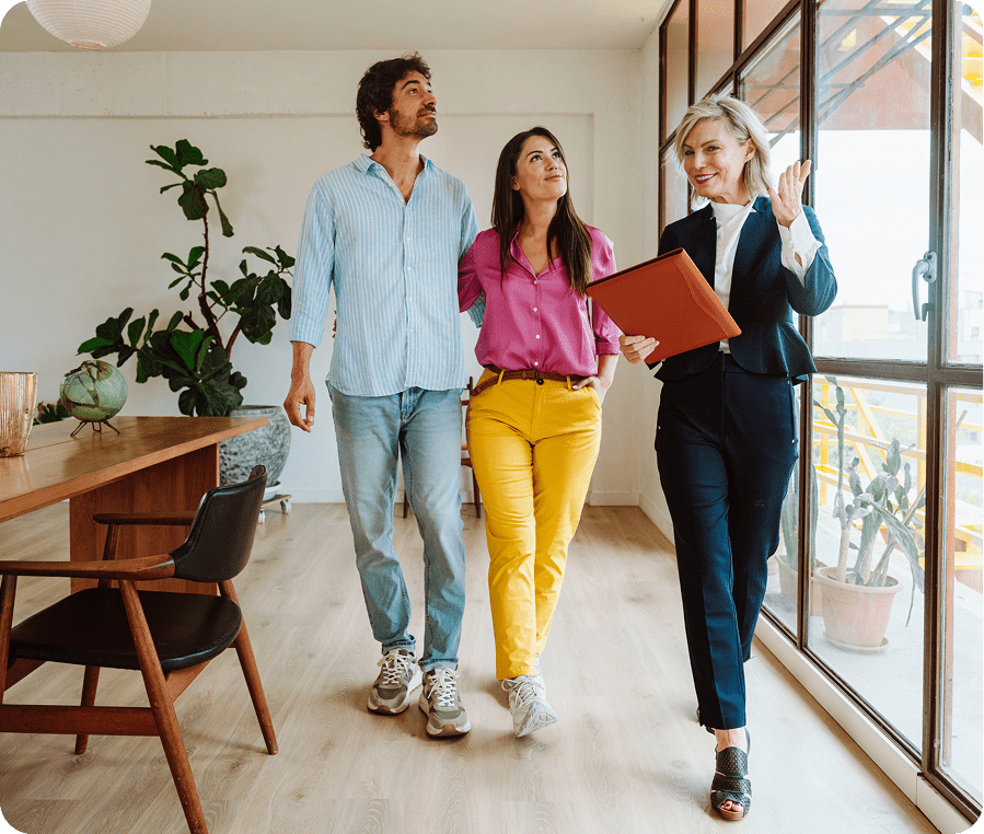 Real estate agent showing couple new home.