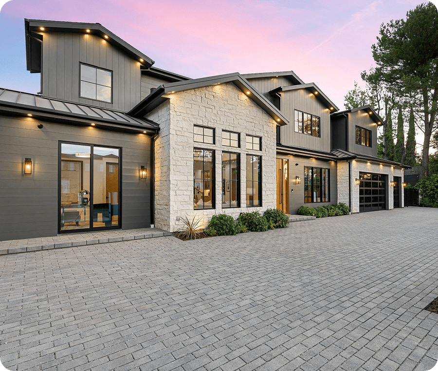 Modern house with large windows at sunset.
