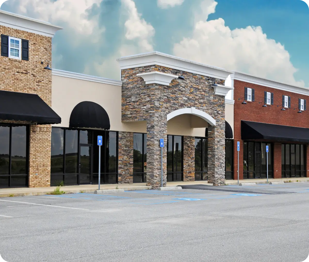 Empty storefronts in a small shopping center.
